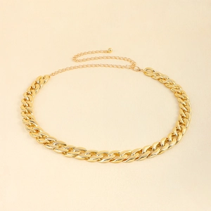 Detail of gold acrylic waist chain featuring chunky Cuban links and adjustable lobster clasp