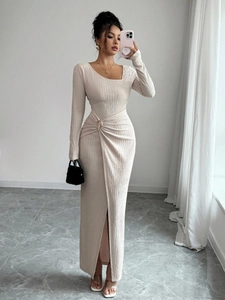 Close-up of beige textured dress featuring waist ruching with a metallic ring detail