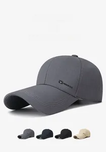 Detail of baseball cap with long brim, metal HEROISM logo, and multiple color options