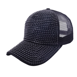 Detail of black baseball cap featuring elegant pearl bead rows and breathable mesh back