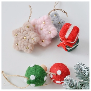 Detailed macro view of felt star and mushroom ornaments for Christmas tree decoration