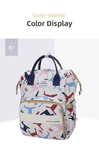 Detailed view of white multipurpose diaper backpack with colorful animal patterns and sturdy handles