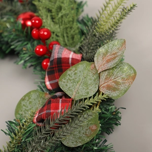 Christmas wreath with artificial eucalyptus pine needles red berries and buffalo plaid ribbon