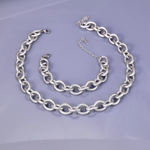 Detail of 13mm silver stainless steel curb chain set with textured spiral pattern links