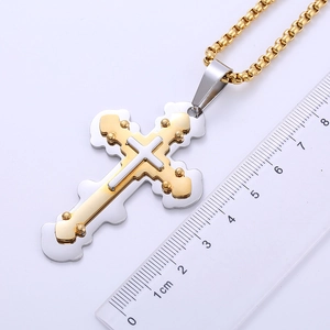 Measurement of two-tone double cross pendant necklace showing 6.5cm height with a ruler