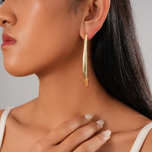 Minimalist 18K gold plated long curved streamlined stud earrings for women on model