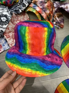 Detailed close-up of rainbow tie-dye bucket hat showing high-quality twill fabric texture