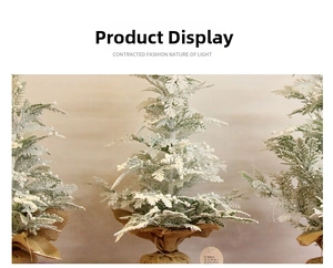 Three mini flocked Christmas trees with snow effect and rustic burlap bases for decor