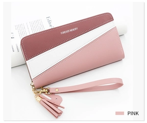 Detailed view of pink tricolor patchwork wallet with fringe tassel and wrist strap
