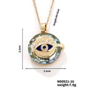 Macro shot of gold Evil Eye necklace with blue enamel, crystals and detailed dimensions
