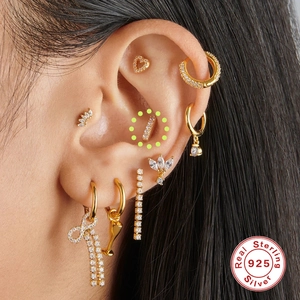 925 sterling silver gold stud earring set with zircons shown on model ear cartilage
