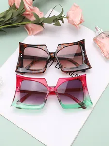 Detail view of oversized butterfly sunglasses with gradient lenses and tortoise shell frames