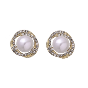 Close-up of gold stud earrings with white pearl center surrounded by crystal rhinestones