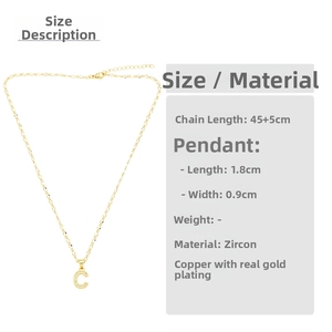 Close-up of golden letter C necklace with micro-pave cubic zirconia on copper gold plating