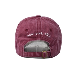 Detailed back view of a washed burgundy baseball cap with white New York City embroidery