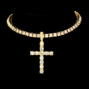 Macro detail of gold hip-hop necklace with large iced-out cross pendant and tennis chain