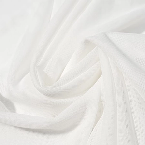 Macro shot of elegant white mesh fabric texture and woven patterns on the dress