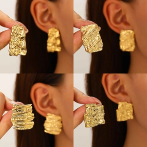 Detailed close-up of gold square earrings with irregular hammered texture and metallic finish