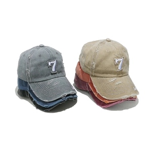 Vintage distressed baseball caps with embroidered number 7 in various faded colors