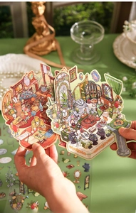 Detailed close-up of 3D scrapbooking stickers with vintage interior art and gold foil