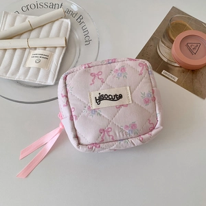 Pink quilted square storage pouch featuring floral patterns and a cute bow design