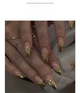 Detail of pink press-on nails with luxury gold tips and 3D almond shape manicure