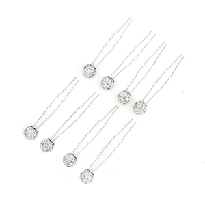Detailed view of silver U-shaped hair pins set with sparkling white crystal rhinestones