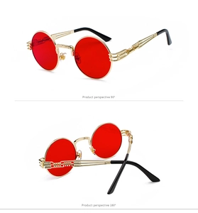Detail view of steampunk round metal sunglasses with red lenses and spiral texture frames