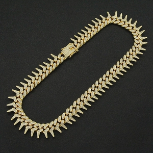 Iced out gold spiked Cuban link chain with geometric pavé crystals for men