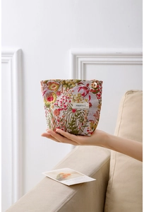 Close-up of vintage floral jacquard fabric with colorful embroidery and woven brand label