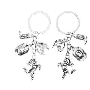 Antique silver Western cowboy keychain with horse, hat, and boot charms in a flat layout
