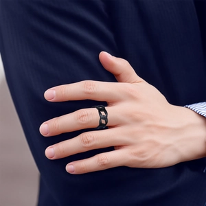 Detail of 9mm matte black punk chain link ring on male finger with navy suit background