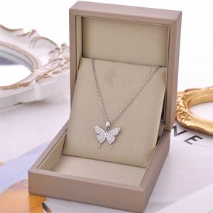 Elegant silver butterfly pendant necklace with cubic zirconia in a leather jewelry box