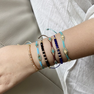 Detailed view of bohemian crystal beaded bracelets with intricate woven patterns on wrist