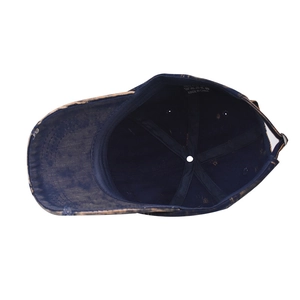 Detail view of cotton inner lining and washing label of vintage washed denim baseball cap