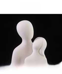 Close-up of white matte ceramic abstract couple sculpture with fine frosted texture detail