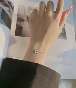 Close-up of a silver hexagram star bracelet with sparkling zircons on a model wrist