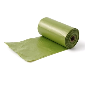 Detail showing a single roll of green degradable pet waste bags partially unrolled