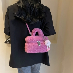Chic pink faux fur square handbag with plush pom-pom charm and silver-tone metal hardware