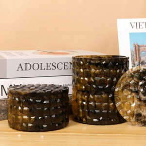Macro shot of amber resin stackable storage box with diamond cut texture and gold leaf