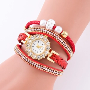 Detail of red multilayer wrap watch with woven cords, golden chains and crystals
