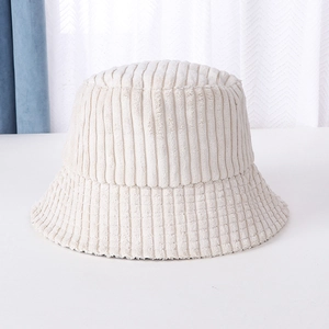 Detailed view of cream corduroy bucket hat with vertical texture on a white surface