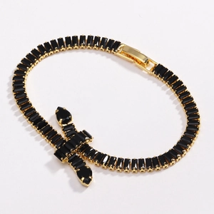 Close-up of gold tennis bracelet featuring black zircon stones and cross charm detail