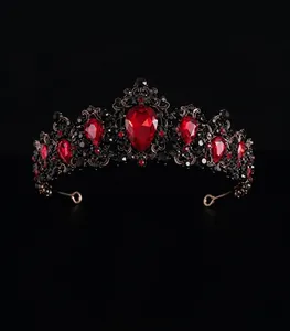 Detailed front view of Baroque bridal crown with red teardrop rhinestones and gold alloy