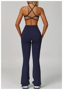 Detail view of navy blue high-waist flared yoga pants and criss-cross back sports bra
