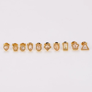 Set of 10 gold stainless steel stud earrings with geometric zircons on white background