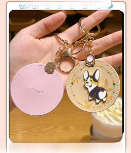 Detail of pink and beige leather Corgi keychains with gold metal lobster clasps