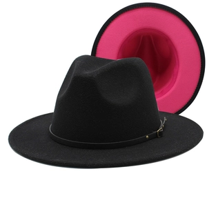 Detail of wool fedora hat showing red and black color block brim with metal buckle