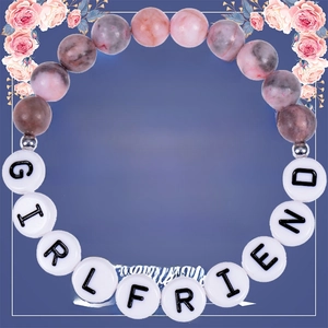 Detail of pink zebra stone bead bracelet with GIRLFRIEND letter beads on a gift card