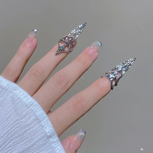 Macro detail of futuristic silver fingernail ring with cubic zirconia and hollow geometry